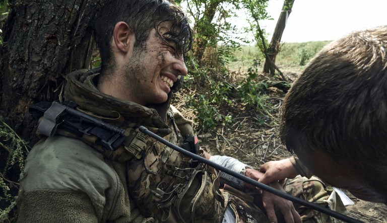 A soldier of Ukraine's 3rd Separate Assault Brigade gives first aid to his 19-year-old wounded comrade, near Bakhmut, the site of fierce battles with the Russian forces in the Donetsk region, Ukraine, Monday, Sept. 4, 2023.