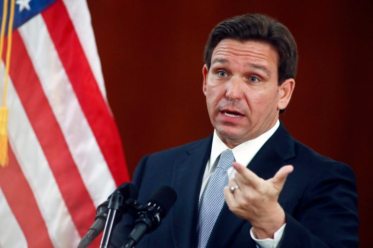 FILE - Florida Gov. Ron DeSantis answers questions from the media in the Florida Cabinet following his State of the State address during a joint session of the Senate and House of Representatives on March 7, 2023, at the state Capitol in Tallahassee, Fla. (AP Photo/Phil Sears, File)