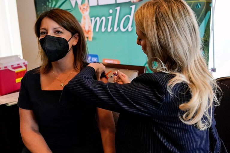 Dr. Mandy Cohen, director of the Centers for Disease Control and Prevention, receives a flu vaccine from Nurse Practitioner Whitney Goggans at the Atlanta Press Club, where Cohen spoke about health concerns, Wednesday, Sept. 6, 2023, in Atlanta. 