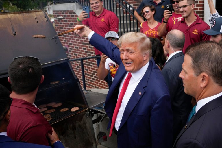 Trump flips burgers with fans at tailgate for Iowa-Iowa State matchup