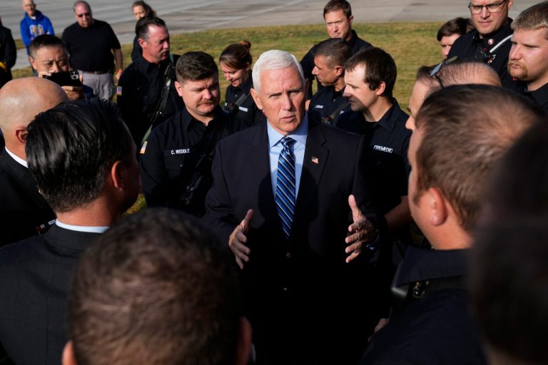 Republican presidential candidate former Vice President Mike Pence talks with firefighters during a 9/11 Remembrance Ceremony at the Ankeny Fire Department on Monday, Sept. 11, 2023, in Ankeny, Iowa. 