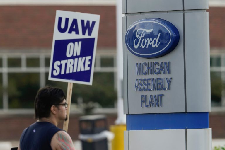 A United Auto Workers members walk a picket line during a strike at the Ford Motor Company Michigan Assembly Plant in Wayne, Mich., Friday, Sept. 15, 2023.