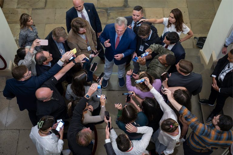 FILE - Speaker of the House Kevin McCarthy (R-CA) is surrounded by reporters looking for updates on plans to fund the government and avert a shutdown at the Capitol in Washington, Friday, Sept. 22, 2023. McCarthy has turned to a strategy that has so far preserved his tenuous hold on House leadership but also marked it by chaos. He is facing a fast-approaching government shutdown that threatens to disrupt life for millions of people.