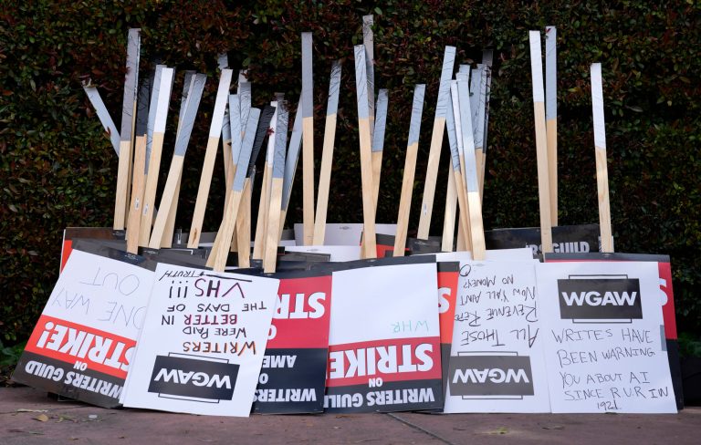 Placards are gathered together at the close of a picket by members of the Writers Guild of America outside Walt Disney Studios, Tuesday, May 2, 2023, in Burbank, California. On Sunday, Sept. 24, 2023, a tentative deal was reached to end Hollywoodâs writers strike after nearly five months.
