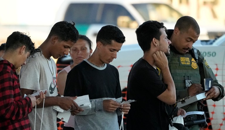 Migrants who crossed the Rio Grande and entered the U.S. from Mexico are lined up for processing by U.S. Customs and Border Protection, Saturday, Sept. 23, 2023, in Eagle Pass, Texas.