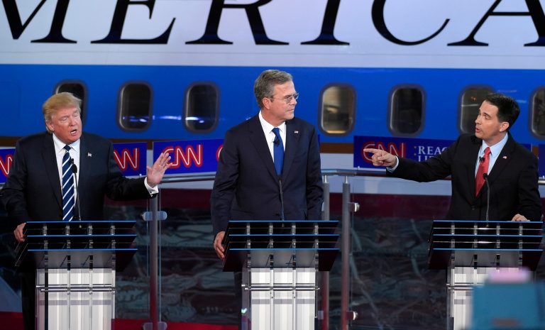 FILE - Republican presidential candidates businessman Donald Trump, left, and Scott Walker, right, both speak as Jeb Bush listens during a 2015 debate.