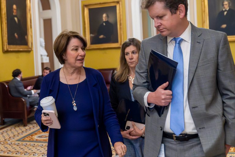 Sen. Amy Klobuchar (D-MN) left, walks with an aide at the Capitol, Thursday, Sept. 28, 2023, in Washington.