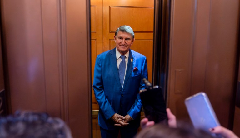 Sen. Joe Manchin (D-WV) stands as the elevator doors close after a closed-door caucus meeting at the Capitol, Thursday, Sept. 28, 2023, in Washington. The meeting discussed the federal charges of bribery against Sen. Bob Menendez (D-NJ).