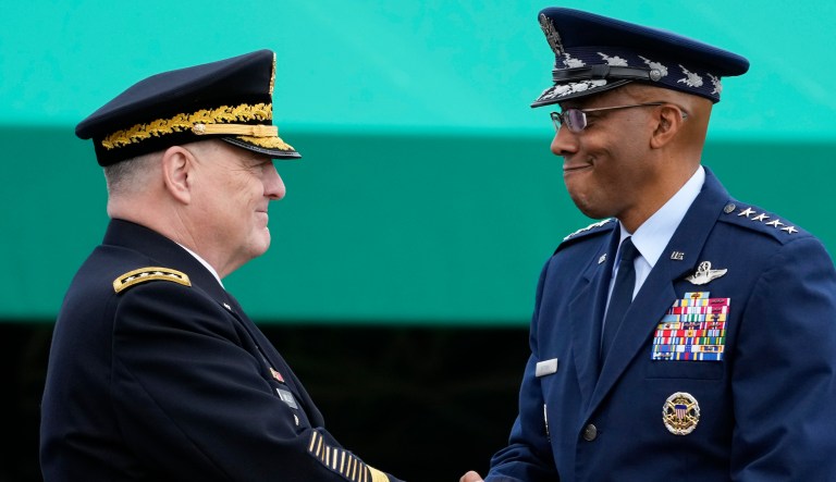 Retiring Chairman of the Joint Chiefs of Staff Gen. Mark Milley, left, shakes hands with Gen. CQ Brown, Jr., the incoming chairman, right, on Friday, Sept. 29, 2023, in Fort Meyer, Va. 