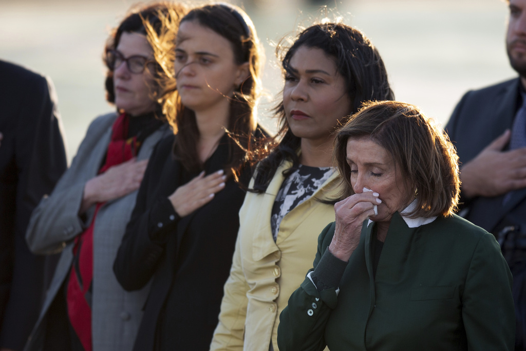 Mourners, including her daughter Katherine Feinstein, left, San Francisco Mayor London Breed, second from right, and Rep. Nancy Pelosi (D-CA), gather at San Francisco International Airport to receive the body of Sen. Dianne Feinstein (D-CA) on Sept. 30, 2023, in San Francisco.