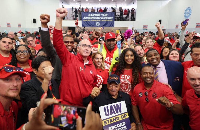 United Auto Workers President Shawn Fain, center left, stands for pictures with the Rev. Jesse Jackson, bottom center, after a rally for striking workers at UAW Local 551 on Saturday, Oct. 7, 2023, in Chicago.