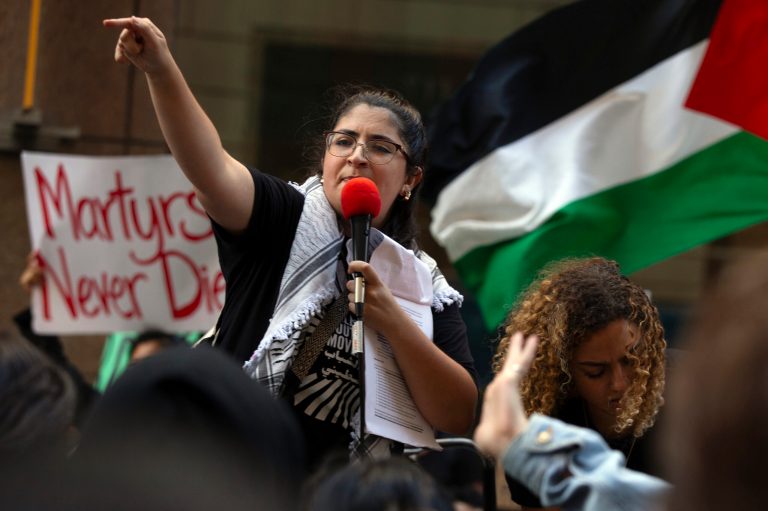 An unidentified demonstrator leads chants during a pro-Palestinian demonstration outside the Israeli Embassy, Sunday, Oct. 8, 2023, in San Francisco.