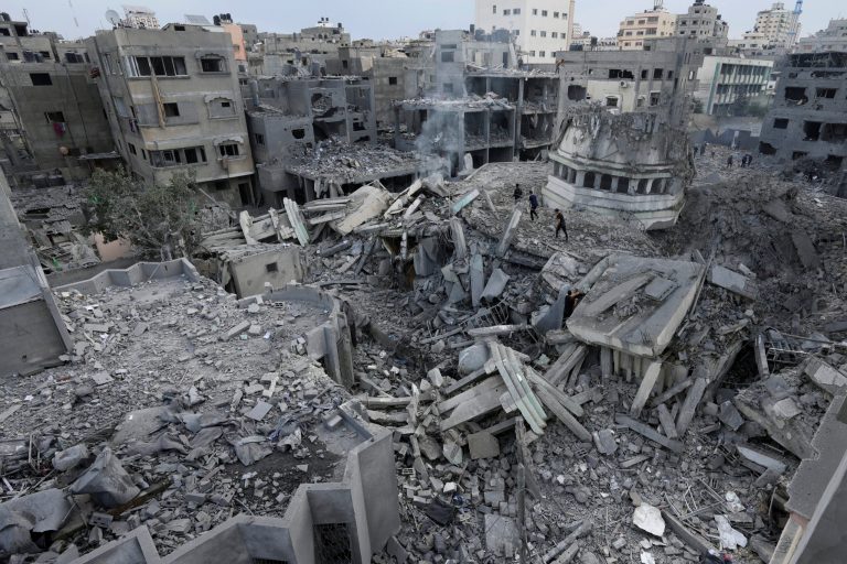 Palestinians inspect the rubble of the Yassin Mosque destroyed after it was hit by an Israeli airstrike in Gaza City early Monday, Oct. 9, 2023. Israel's military battled to drive Hamas fighters out of southern towns and seal its borders Monday as it pounded the Gaza Strip.