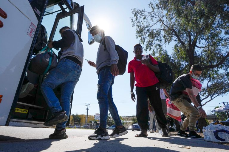 Migrants board a bus to the airport Friday, Oct. 6, 2023, in San Diego. San Diego's well-oiled system of migrant shelters is being tested like never before as U.S. Customs and Border Protection releases migrants to the streets of California's second-largest city because shelters are full.