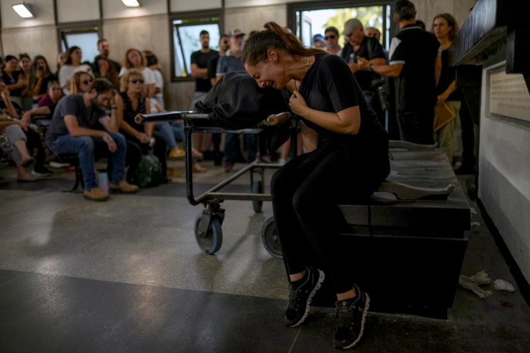 Mourners react beside the body of Mapal Adam during her funeral in Tel Aviv, Israel, Wednesday, Oct. 11, 2023.