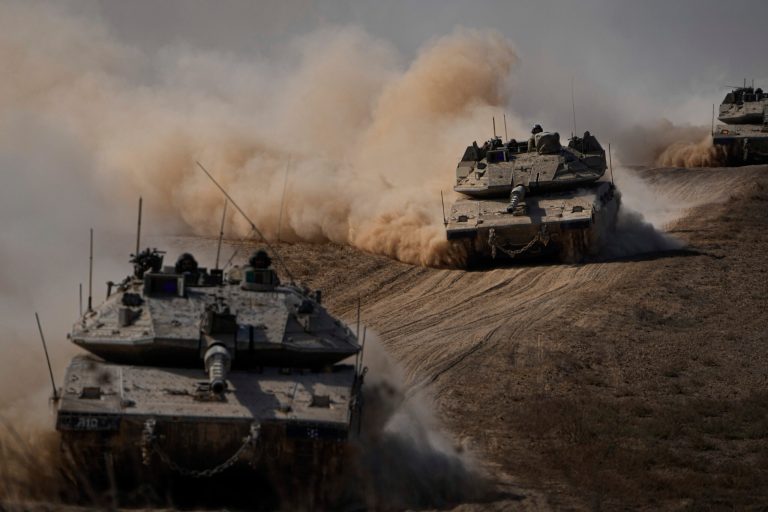Israeli tanks head toward the Gaza Strip border in southern Israel on Friday, Oct.13, 2023.