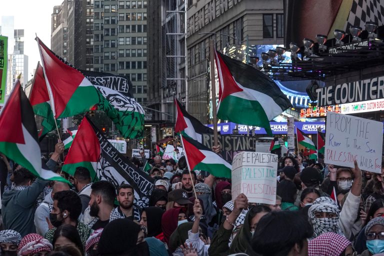 Palestinian supporters march with flags and signs and chant in protest, Friday, Oct. 13, 2023, in New York, as the Israel-Hamas war continues.
