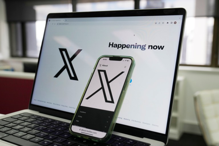 The opening page of X is displayed on a computer and phone.