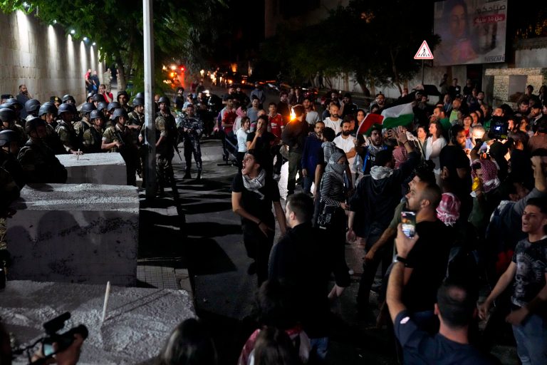 Demonstrators throw stones during a protest in solidarity with the Palestinian people in Gaza, in Beirut, Lebanon, Tuesday, Oct. 17, 2023. 