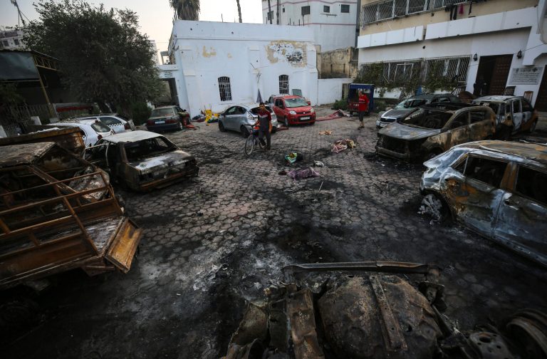 Palestinians look at the site of the explosion at al Ahli hospital in Gaza City, Wednesday, Oct. 18, 2023.