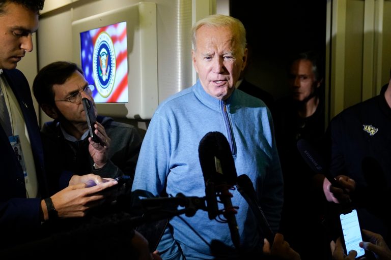 President Joe Biden speaks to the media on Air Force One during a refueling stop at Ramstein Air Base, Germany, Wednesday, Oct. 18, 2023.