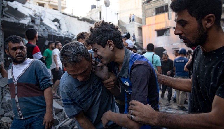 Palestinians react after an Israeli bombardment in Khan Younis, Gaza Strip, Thursday, Oct. 19, 2023.