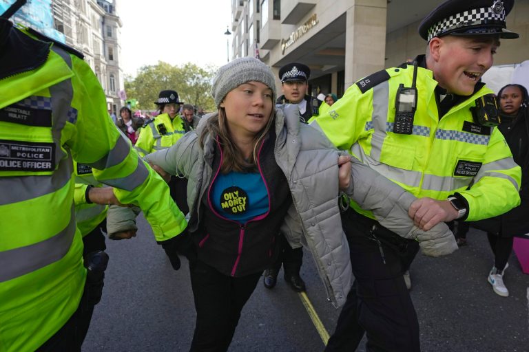Environmental activist Greta Thunberg is taken away by police officers during the Oily Money Out protest outside the Intercontinental Hostel in London on Tuesday, Oct. 17, 2023. 