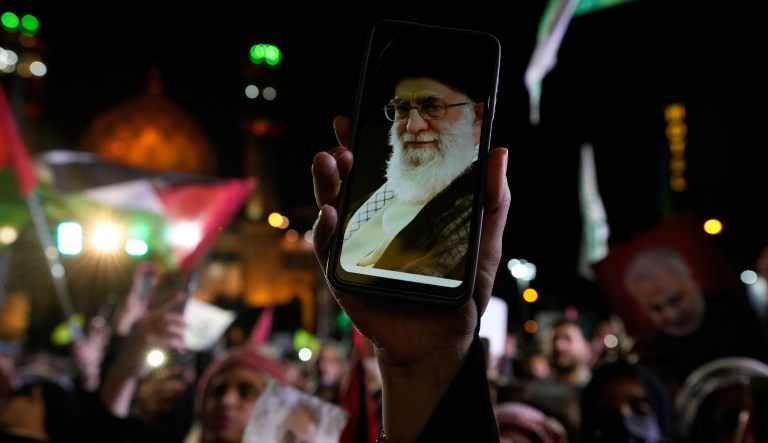 An Iranian demonstrator shows a photos of the Supreme Leader Ayatollah Ali Khamenei on the screen of her cellphone in a pro-Palestinian rally at the Felestin (Palestine) Sq. in Tehran, Iran, Friday, Oct. 20, 2023.