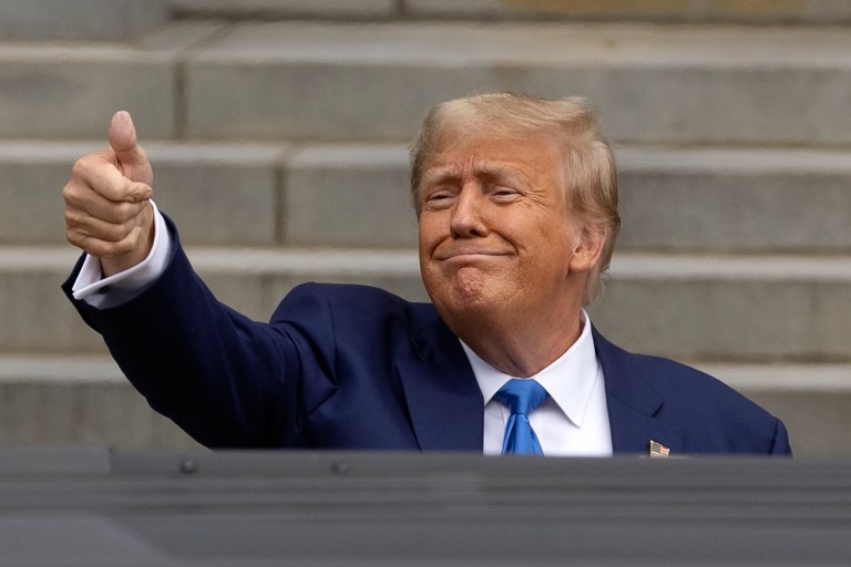 Former President Donald Trump gives a thumbs-up to supporters as he leaves the New Hampshire Statehouse after signing papers to get on the Republican presidential primary ballot, Monday, Oct. 23, 2023, in Concord, New Hampshire.