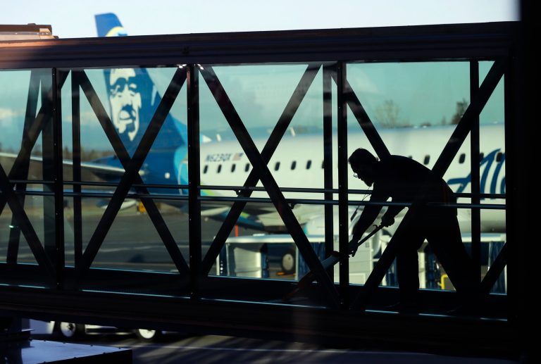 A worker cleans a jet bridge at Paine Field in Everett, Washington, before passengers board an Alaska Airlines flight on March 4, 2019. Seattle-based Alaska Airlines owns Horizon Air. An off-duty pilot riding in the extra seat in the cockpit of a Horizon Air passenger jet on Sunday, Oct. 22, 2023, tried to shut down the engines in mid-flight and had to be subdued by the crew, according to a pilot flying the plane.