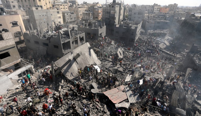 Palestinians inspect the rubble of destroyed buildings following Israeli airstrikes on the town of Khan Yunis, southern Gaza Strip, Thursday, Oct. 26, 2023. 