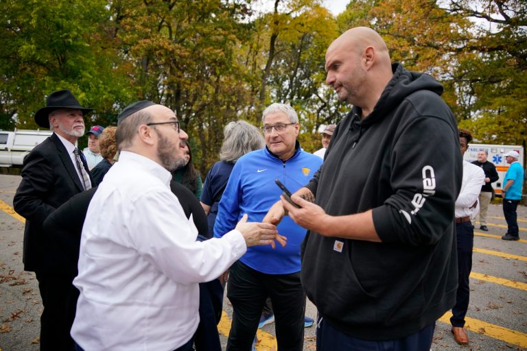 Sen. John Fetterman (D-PA), right, visits with people before a Commemoration Ceremony on Friday, Oct. 27, 2023, in Schenley Park, in the Squirrel Hill neighborhood of Pittsburgh, to remember the 11 worshippers killed by a gunman at the Tree of Life synagogue five years ago.