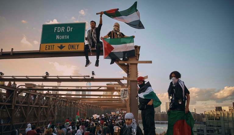 Protesters shout slogans as they cross Brooklyn Bridge during a Pro-Palestine demonstration demanding the ceasefire on Saturday, Oct. 28, 2023, in New York.