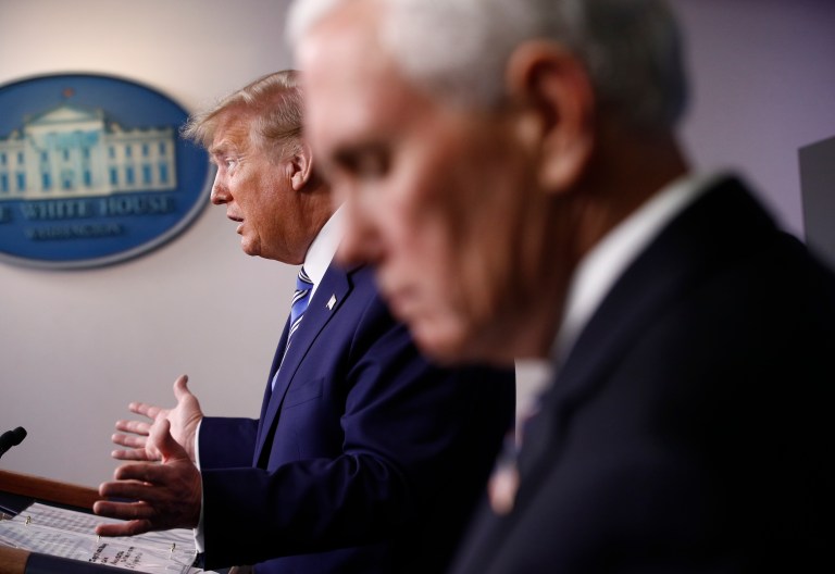 Vice President Mike Pence, right, listens as President Donald Trump speaks during a coronavirus task force briefing at the White House, Sunday, April 19, 2020, in Washington.