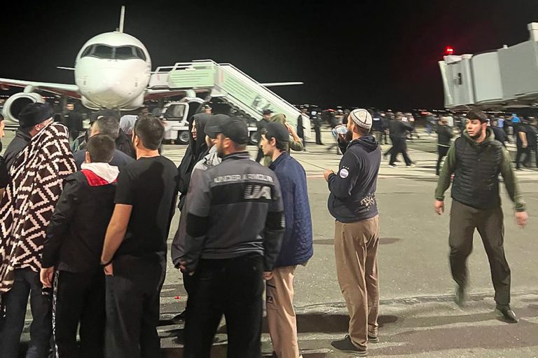 People in the crowd walk, shouting antisemitic slogans at an airfield of the airport in Makhachkala, Russia, Monday, Oct. 30, 2023. 