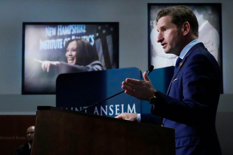 Rep. Dean Phillips (D-MN) addresses guests near a photograph of Vice President Kamala Harris, at rear left, during a campaign stop, Tuesday, Oct. 31, 2023, in Manchester, New Hampshire.