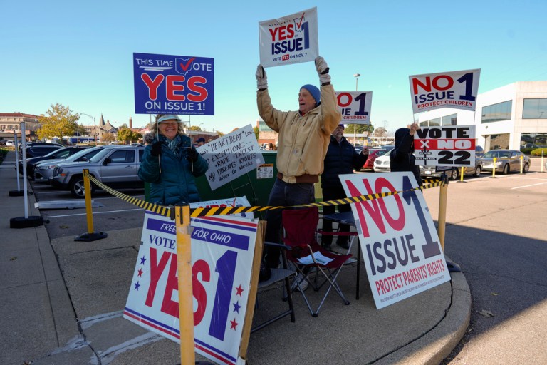People gather in the parking lot of the Hamilton County Board of Elections as people arrive for early in-person voting in Cincinnati, Thursday, Nov. 2, 2023. 