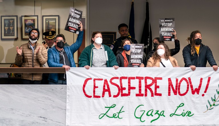 Anti-war activists demonstrate outside the office of Sen. Jeff Merkley (D-OR) in the Hart Senate Office Building, just as the Republican-controlled House approved a partisan $14.5 billion military aid package for Israel, but without humanitarian assistance for Gaza, at the Capitol in Washington, Friday, Nov. 3, 2023. Democrats say that approach would only delay help for Israel. Senate Majority Leader Chuck Schumer (D-NY) has warned that the 