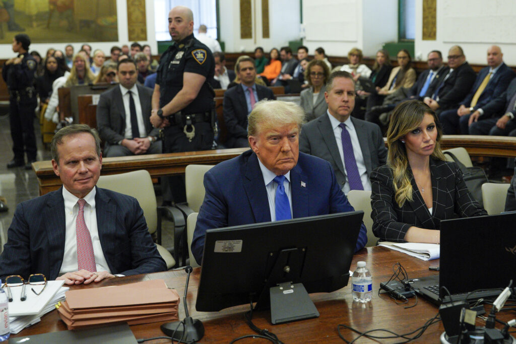 Flanked by his attorneys Chris Kise, left, and Alina Habba, former President Donald Trump waits to take the witness stand at New York Supreme Court, Monday, Nov. 6, 2023, in New York. 