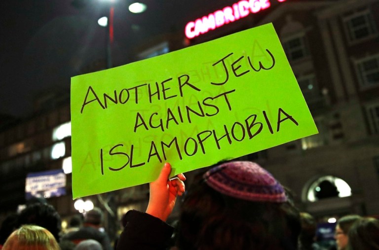 A sign is held up during a protest by several hundred people organized by the Harvard Islamic Society near the campus of Harvard University in Cambridge, Massachusetts, March 7, 2017. The Biden administration is warning U.S. schools and colleges that they must take immediate action to stop antisemitism and Islamophobia on their campuses, citing an âalarming riseâ in threats and harassment.