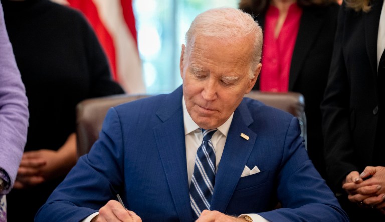 President Joe Biden signs a presidential memorandum in the Oval Office of the White House, Nov. 13, 2023, in Washington. 
