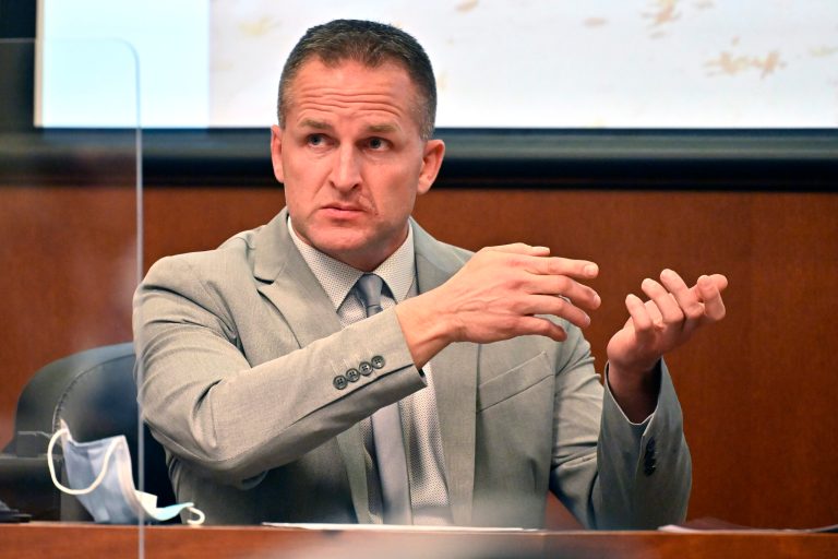 FILE - Former Louisville police officer Brett Hankison talks about seeing a subject in a firing stance in the apartment as he is cross-examined in Louisville, Kentucky, March 2, 2022.