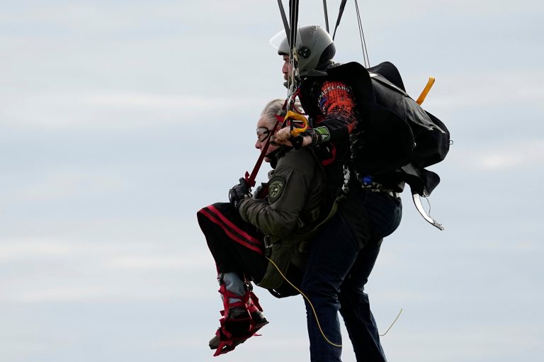 Texas Gov. Greg Abbott skydives in tandem on Monday, Nov. 27, 2023, in Fentress, Texas. Abbott was invited to jump by 106-year-old World War II veteran Al Blaschke.