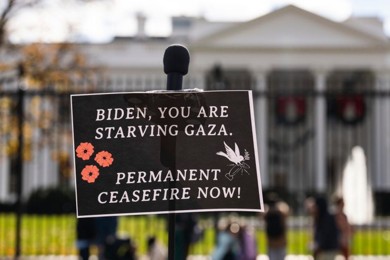 A sign is seen at a news conference outside the White House on Nov. 27, 2023.