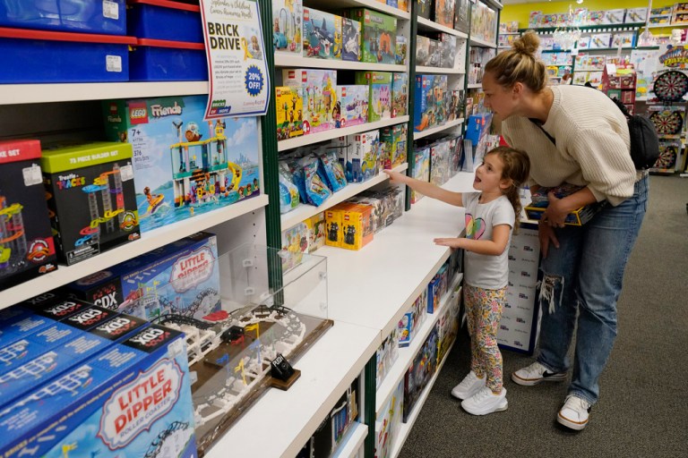 FILE  -Quinn Byrne, 5, shops with her mother, Jamie Byrne, at a Learning Express store in Lake Zurich, Ill., Tuesday, Sept. 26, 2023.  (AP Photo/Nam Y. Huh, File)