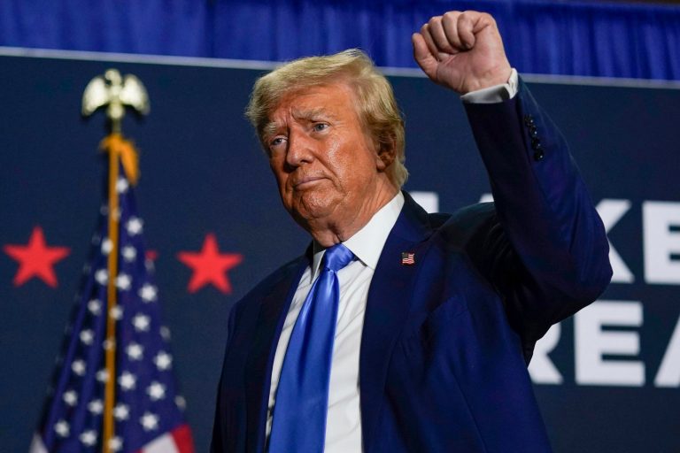 Republican presidential candidate Donald Trump gestures after speaking at a campaign rally on Oct. 23, 2023, in Derry, New Hampshire. Trump's lawyers have suggested their strategy in his election interference case in Washington involves distancing their client from the horde of U.S. Capitol rioters, whom the former president has embraced on the campaign trail.