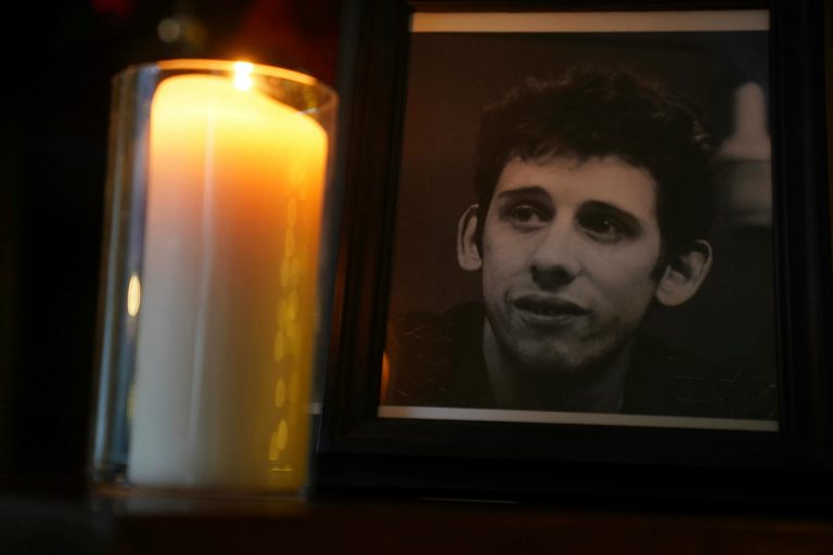 A candle burns next to a photograph of the Pogues frontman Shane MacGowan at the Mansion House, in Dublin, Thursday, Nov. 30, 2023. MacGowan, the singer-songwriter and frontman of the Pogues, best known for their ballad âFairytale of New York,â has died. He was 65. His family said in a statement that 