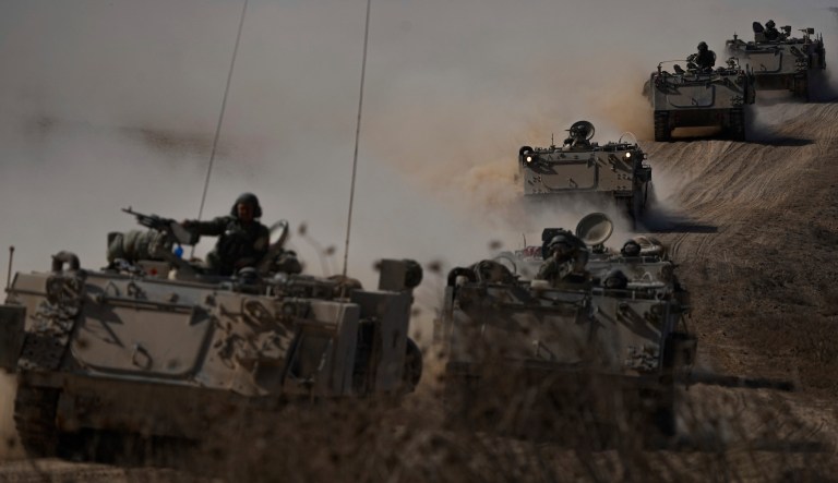 Israeli armored personnel carriers head toward the Gaza Strip border in southern Israel on Oct.13, 2023.