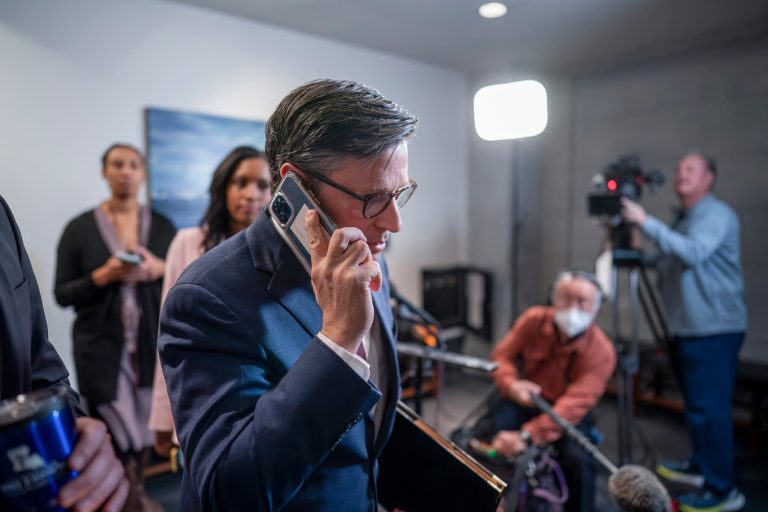 Speaker of the House Mike Johnson (R-LA) talks on his phone before the House vote to expel Rep. George Santos (R-NY) from Congress on Friday, Dec. 1, 2023, at the Capitol in Washington.
