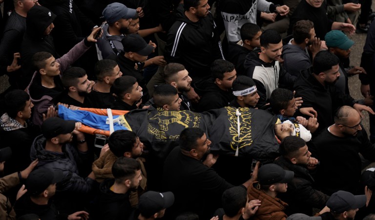 Mourners carry the body of Moaz Zahran, draped in the Islamic Jihad militant group flag during his funeral on Wednesday, Dec. 6, 2023, at Al-Far'a Camp, West Bank. Palestinian health officials say that the Israeli military raided parts of the northern West Bank, sparking clashes with local militants that killed two Palestinians.